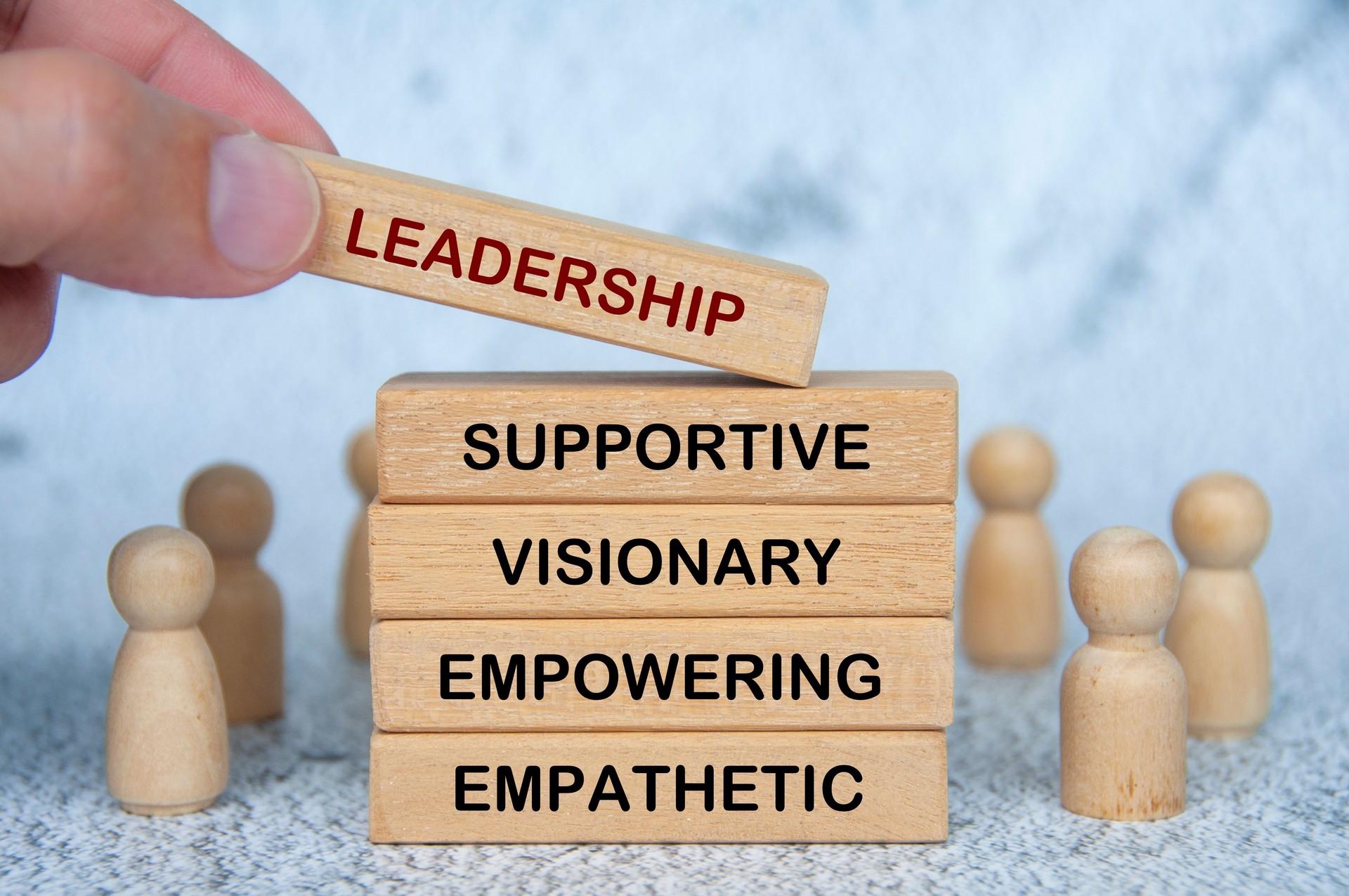 LEADERSHIP, SUPPORTIVE, VISIONARY, EMPOWERING and EMPATHETIC text on wooden blocks. Leadership concept.